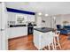 Open living space with an island, seating, and a kitchen with white cabinets and dark countertops at 333 14Th Ave. S, Surfside Beach, SC 29575