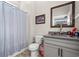 Bathroom with gray cabinet sink and shower curtain at 355 Oak Ave., Murrells Inlet, SC 29576