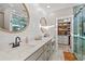 Stylish bathroom featuring double vanity, marble countertops, shiplap walls, and a glass-enclosed shower with walk-in closet at 355 Oak Ave., Murrells Inlet, SC 29576