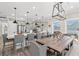 Spacious dining area with a large kitchen island, gray upholstered chairs, and modern pendant lighting at 355 Oak Ave., Murrells Inlet, SC 29576