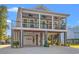 Charming coastal home featuring a double front porch, covered parking, and stylish beachside decor at 355 Oak Ave., Murrells Inlet, SC 29576