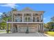 Inviting two-story coastal home with double front porch, light gray facade, and convenient covered parking at 355 Oak Ave., Murrells Inlet, SC 29576