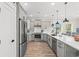 Bright kitchen featuring gray cabinetry, stainless steel appliances, and a sleek white countertop at 355 Oak Ave., Murrells Inlet, SC 29576