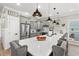 Modern kitchen with gray cabinets, a white marble countertop, stainless steel appliances, and bar stool seating at 355 Oak Ave., Murrells Inlet, SC 29576