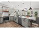 Well-equipped kitchen with gray cabinets, stainless steel appliances, a view to the dining area, and hardwood floors at 355 Oak Ave., Murrells Inlet, SC 29576