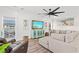 Bright and airy living room with white shiplap walls, a modern ceiling fan, and comfortable sectional sofa at 355 Oak Ave., Murrells Inlet, SC 29576