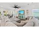 Stylish living room with white shiplap walls, a modern ceiling fan, and comfortable sectional sofa at 355 Oak Ave., Murrells Inlet, SC 29576