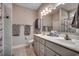 Well-lit bathroom featuring dual sinks, modern fixtures, and a neutral color palette at 377 Copperwood Loop, Conway, SC 29526