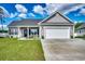 Charming single-story home with a well-manicured lawn, gray siding and white trim, plus an attached two-car garage at 377 Copperwood Loop, Conway, SC 29526