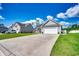 Well-maintained home boasts a long driveway, attached garage, and lush lawn, nestled in a quiet neighborhood at 377 Copperwood Loop, Conway, SC 29526