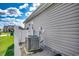 Home exterior showing well-maintained siding, white fence, and efficient air conditioning unit at 377 Copperwood Loop, Conway, SC 29526