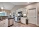 Well-equipped kitchen with white cabinets, stainless steel appliances, and wood-look flooring, offering functionality and style at 377 Copperwood Loop, Conway, SC 29526