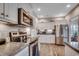 Contemporary kitchen boasts stainless steel appliances, white cabinetry, granite counters and modern subway tile backsplash at 377 Copperwood Loop, Conway, SC 29526
