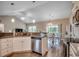 Bright kitchen featuring modern stainless-steel appliances and granite countertops overlooking the dining area at 377 Copperwood Loop, Conway, SC 29526