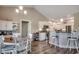 Open concept living space with dining and kitchen area, complete with bar stool seating and modern decor at 377 Copperwood Loop, Conway, SC 29526