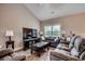 Inviting living room with wood-look floors, neutral tones, and large windows offering plenty of natural light and airy feel at 377 Copperwood Loop, Conway, SC 29526