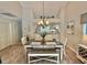 Well-lit dining area with a long table and bench seating; kitchen viewable in the background at 421 Appledore Circle # 5-D, Myrtle Beach, SC 29572
