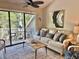 Comfortable living room with a modern couch and access to a private outdoor deck at 421 Appledore Circle # 5-D, Myrtle Beach, SC 29572