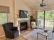 Cozy living area with fireplace, stylish furnishings, and sliding glass doors to the deck at 421 Appledore Circle # 5-D, Myrtle Beach, SC 29572
