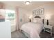 Cozy bedroom featuring decor in pink and white accents, complemented by natural light from the large window at 4344 Falls Oaks St., Myrtle Beach, SC 29579