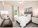 Bright bedroom with neutral decor, a large window, and stylish furnishings at 4344 Falls Oaks St., Myrtle Beach, SC 29579