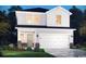 Charming two-story home featuring a two-car garage and professionally landscaped front yard at 4344 Falls Oaks St., Myrtle Beach, SC 29579