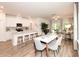 Bright, open-concept kitchen, dining, and living area with hardwood floors and modern furniture at 4344 Falls Oaks St., Myrtle Beach, SC 29579