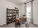 Well-lit home office with a wooden desk, stylish shelving, and neutral decor, ideal for a productive workspace at 4345 Falls Oaks St., Myrtle Beach, SC 29579