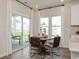 Cozy dining area with a round table, modern chairs, and sliding glass doors leading to outdoor space at 4360 Falls Oaks St., Myrtle Beach, SC 29579