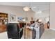 Cozy living room featuring a comfortable gray sofa, a ceiling fan, and a wooden bookcase at 4755 Lightkeepers Way # 15-E, Little River, SC 29566
