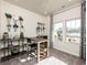 Bright office space featuring a modern desk, decorative shelving, and large windows overlooking the landscape at 4827 Hopespring St., Myrtle Beach, SC 29579