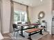 Dining area featuring a modern table, stylish chairs, a large window, and contemporary decor at 5060 Riverton Ct, Myrtle Beach, SC 29579