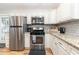 Bright kitchen with stainless steel appliances, granite countertops, and white cabinets at 508 Pearl St., Conway, SC 29527