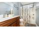 The bathroom features tile floors, light blue walls, a white vanity, and a tub with shower at 524 Cottage Oaks Circle, Myrtle Beach, SC 29579