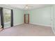 Light green bedroom with tan carpet, ceiling fan, and large window with curtains at 524 Cottage Oaks Circle, Myrtle Beach, SC 29579