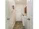 Hallway-style laundry room with tile floors features a front-load washer and dryer, and overhead cabinets at 524 Cottage Oaks Circle, Myrtle Beach, SC 29579