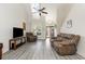 Inviting living room with plush seating, wood floors, and bright natural light at 524 Cottage Oaks Circle, Myrtle Beach, SC 29579