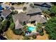 Aerial shot featuring property with pool, patio and lush greenery surrounding the home at 546 Olde Mill Dr., North Myrtle Beach, SC 29582