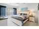 Comfortable bedroom with coastal-themed bedding, white furniture, and a bright window at 5876 Longwood Dr. # 201, Murrells Inlet, SC 29576