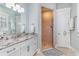 Bright bathroom with granite countertops, white cabinetry, and a tile shower with a glass door at 600 Waterbridge Blvd., Myrtle Beach, SC 29579
