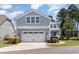 Two-story home with a two-car garage, manicured landscaping, and sidewalk to the front door at 600 Waterbridge Blvd., Myrtle Beach, SC 29579