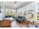 Inviting sunroom with a glass table, comfortable seating, and scenic neighborhood views at 600 Waterbridge Blvd., Myrtle Beach, SC 29579