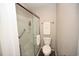 Bathroom featuring a glass-door shower, a toilet, and towel racks at 649 Tupelo Ln. # 13A, Longs, SC 29568