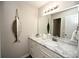 Well-lit bathroom with a marble countertop, stylish decor, and a decorative fish mirror at 649 Tupelo Ln. # 13A, Longs, SC 29568