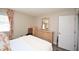 Bedroom features a bright white queen bed, wooden furniture, and white walls at 649 Tupelo Ln. # 13A, Longs, SC 29568
