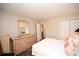 Bright bedroom featuring white queen bed with wicker dresser and a view to the bath at 649 Tupelo Ln. # 13A, Longs, SC 29568