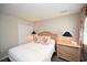 Bedroom features a queen bed, wicker furniture, closet, and decorative coral pillows at 649 Tupelo Ln. # 13A, Longs, SC 29568