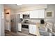 Modern kitchen with stainless steel appliances, granite countertops, and white cabinets at 649 Tupelo Ln. # 13A, Longs, SC 29568