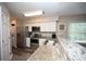 Bright kitchen features stainless steel appliances, light countertops, and white cabinets at 649 Tupelo Ln. # 13A, Longs, SC 29568