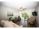 Bright living room featuring stylish decor, a ceiling fan, and access to a patio at 649 Tupelo Ln. # 13A, Longs, SC 29568